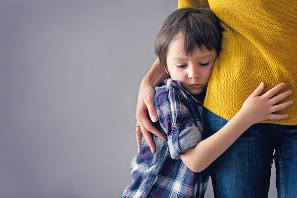 Child hugging mother after the death of a loved one