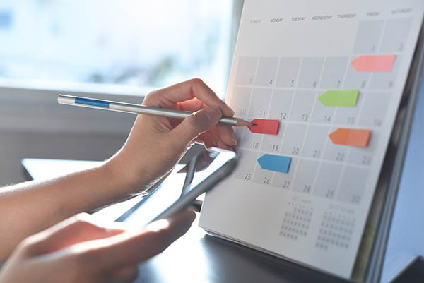 Divorced mom managing co-parenting schedule with child's digital calendar
